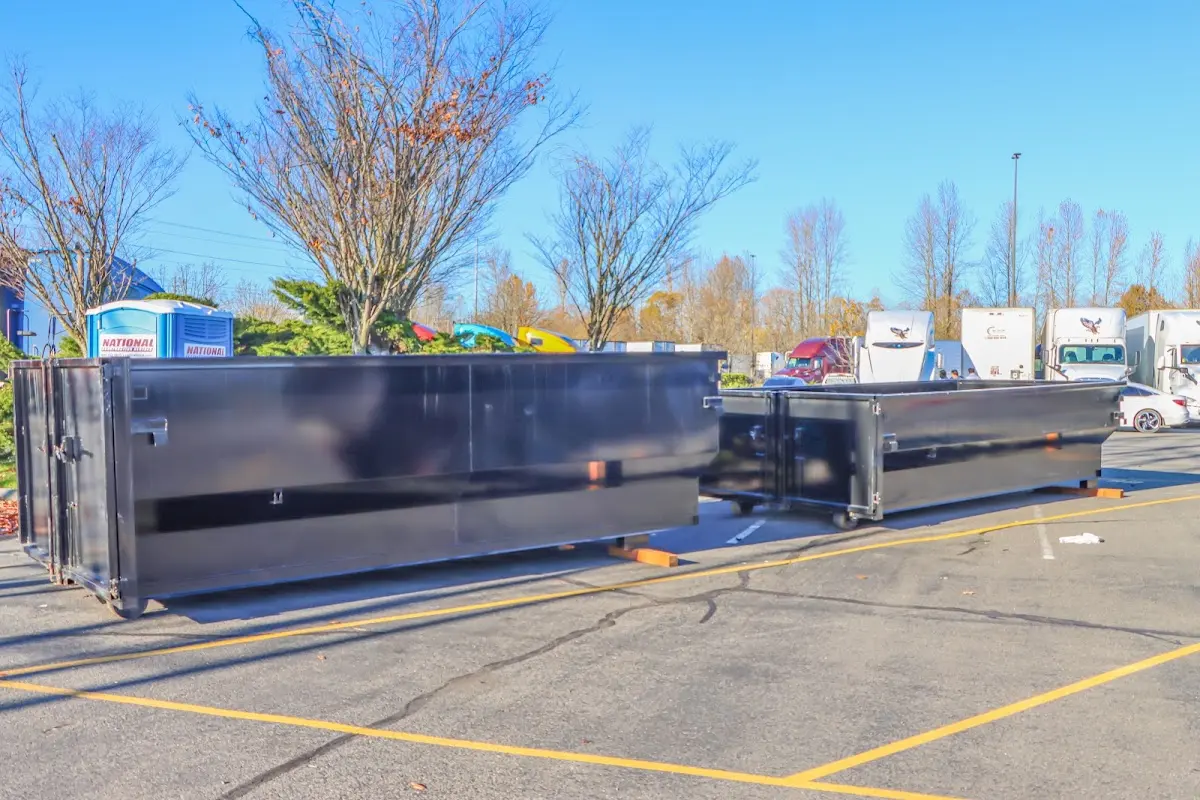 Professional dumpster rental service with roll-off container on residential driveway in Peru